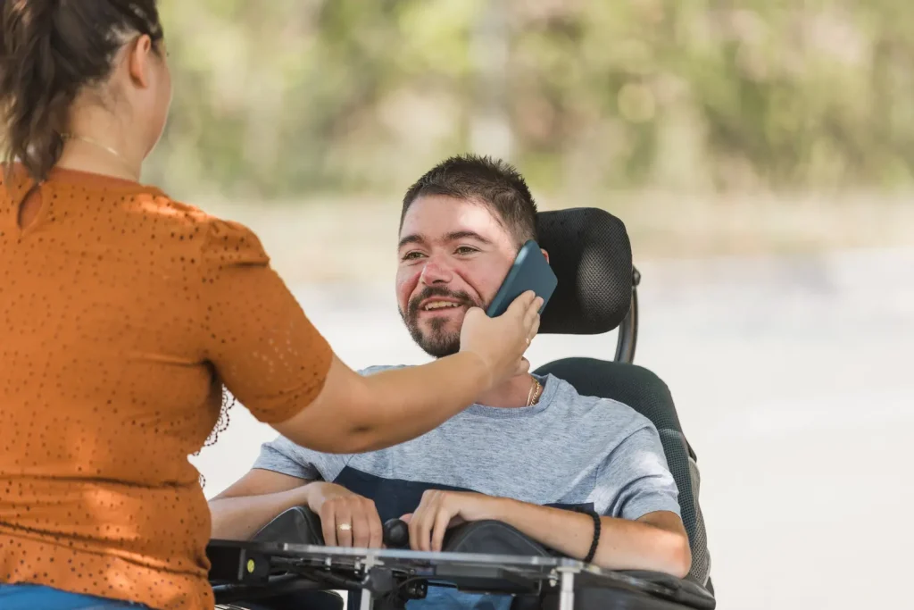 Disabled man on the phone contacting Life Improvements