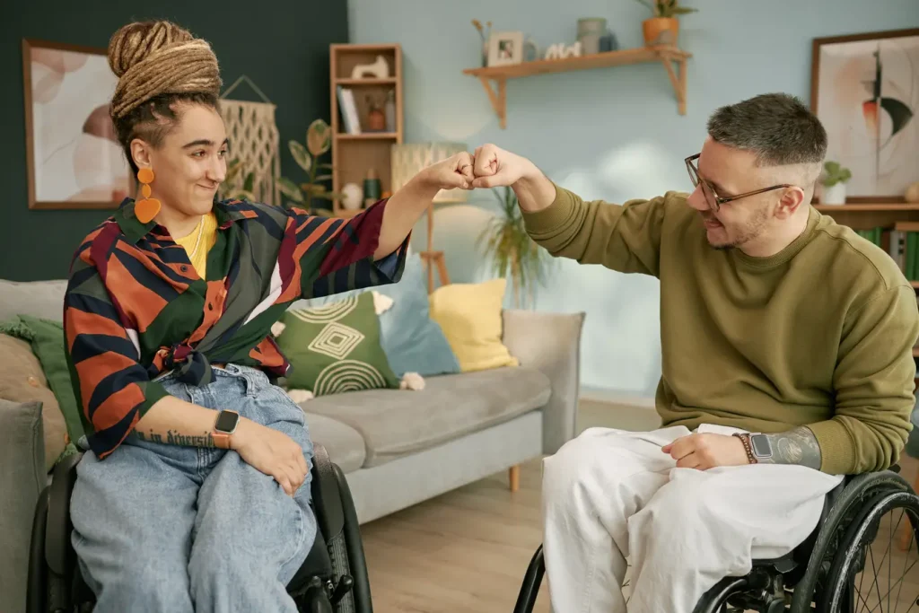 Disabled man and woman fist bumping